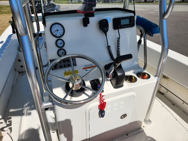 Slide: The Image of 2015 Sundance B20CCR boat console with steering wheel, gauges, and communication equipment. - 8