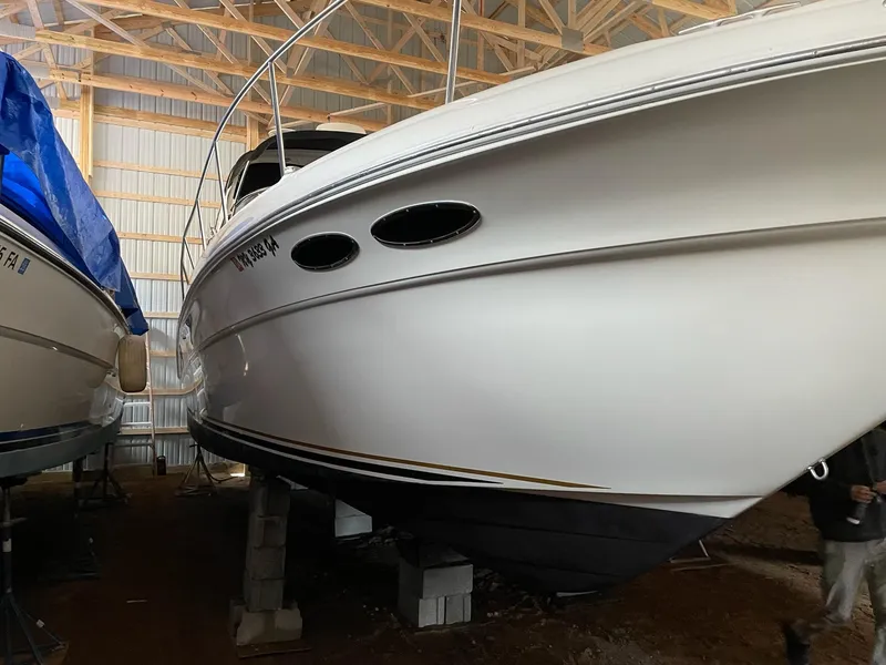 Slide: The Image of 2000 Sea Ray 340 Sundancer boat stored indoors on blocks. - 13