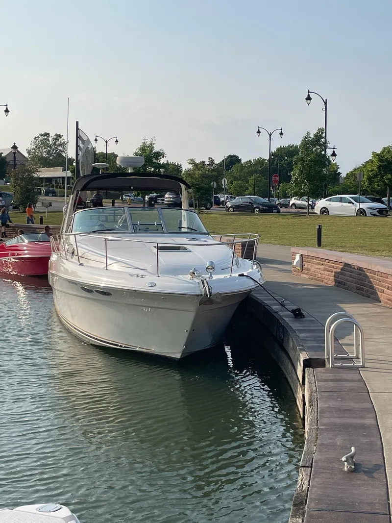 Slide: The Image of 2000 Sea Ray 340 Sundancer docked in a serene marina setting. - 9