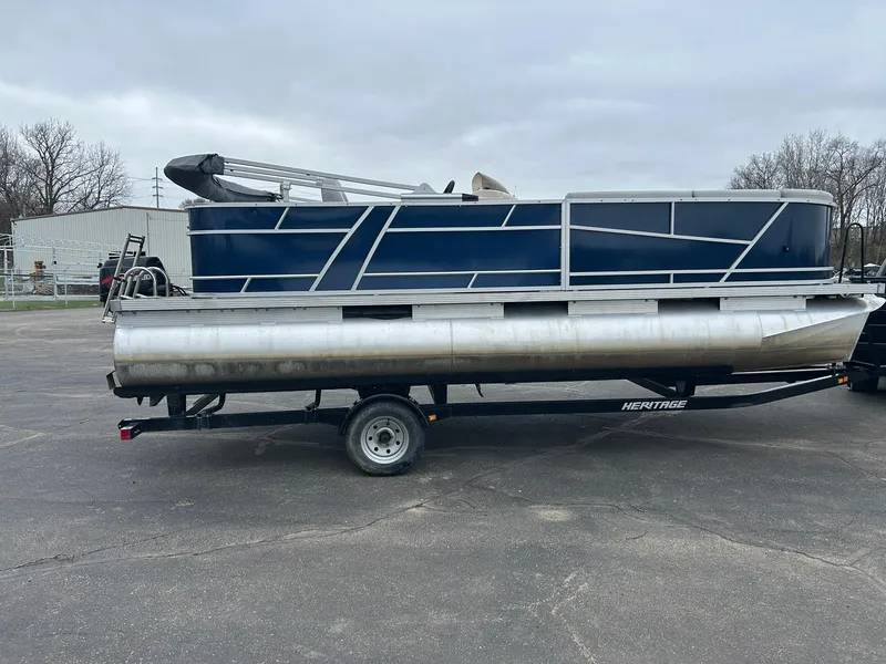 Slide: The Image of 1999 Sylvan 20 Cruise pontoon boat on trailer, parked outdoors. - 3