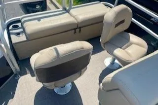 Slide: The Image of 2023 Sun Tracker SportFish 22 DLX interior with beige seating and cup holders. - 4