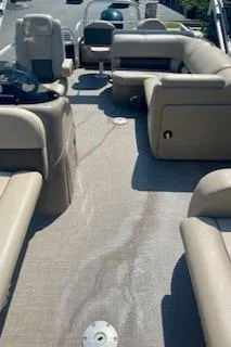 Slide: The Image of 2023 Sun Tracker SportFish 22 DLX pontoon boat interior with beige seating and spacious layout. - 7