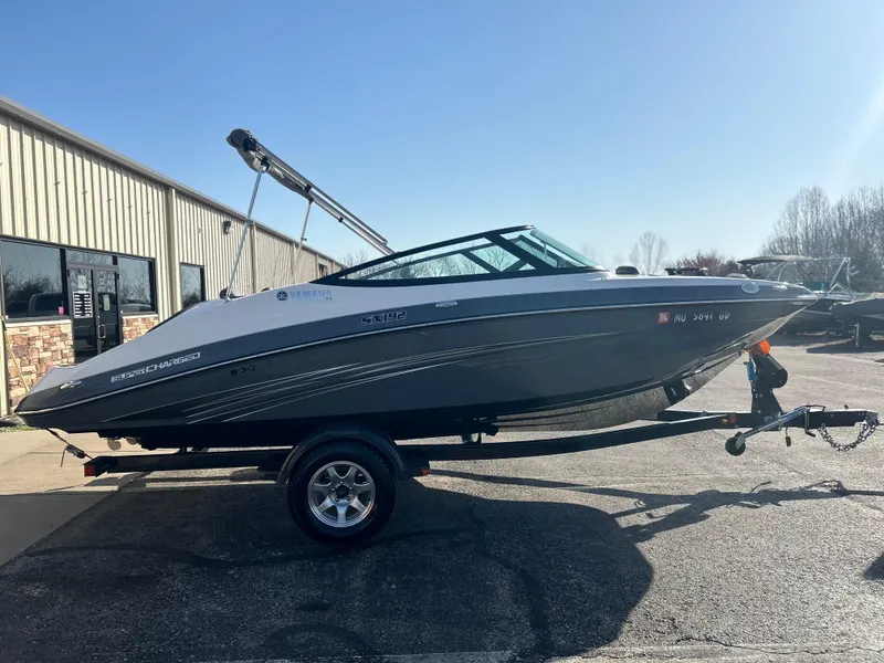 Slide: The Image of 2015 Yamaha Boats SX192 on trailer, parked outdoors near a building. - 1