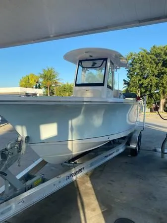 Slide: The Image of 2021 Sea Hunt Ultra 255 SE boat on trailer, parked outdoors. - 1