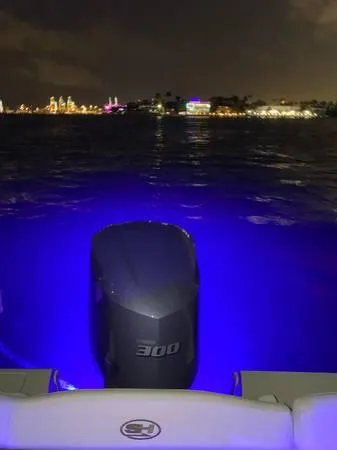 Slide: The Image of 2021 Sea Hunt Ultra 255 SE boat with illuminated water at night. - 3
