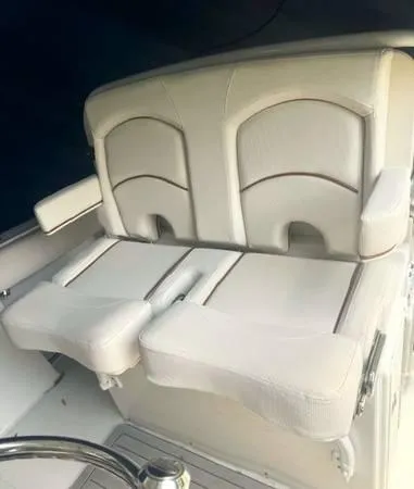 Slide: The Image of 2021 Sea Hunt Ultra 255 SE boat seating, featuring white cushioned dual seats. - 5