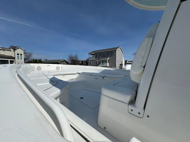 Slide: The Image of 2020 Regulator 26XO boat interior with white seating, residential background. - 17