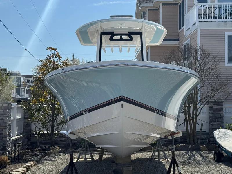 Slide: The Image of 2020 Regulator 26XO boat on display in a residential area. - 2