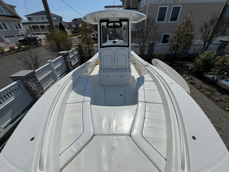 Slide: The Image of 2020 Regulator 26XO boat with spacious seating, docked in a residential area. - 21