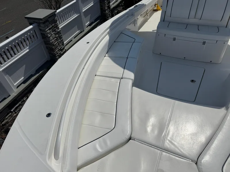 Slide: The Image of 2020 Regulator 26XO boat with white cushioned seating and storage compartments. - 23