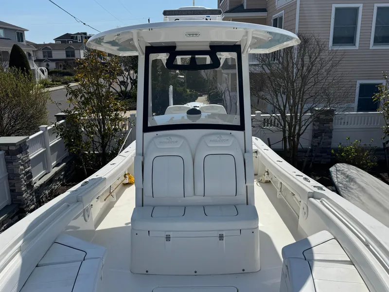 Slide: The Image of 2020 Regulator 26XO boat with center console and seating, docked near residential area. - 24