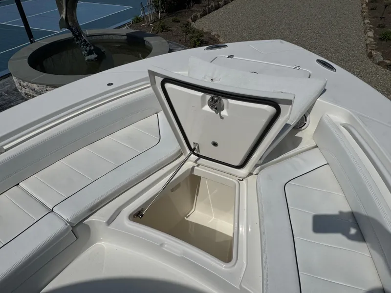 Slide: The Image of 2020 Regulator 26XO boat with open storage compartment on deck. - 29