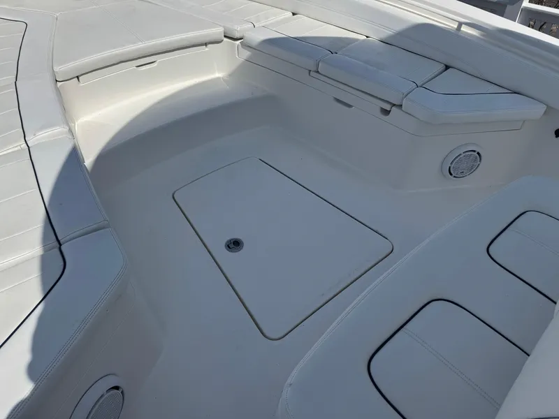 Slide: The Image of 2020 Regulator 26XO boat interior with cushioned seating and storage compartments. - 31
