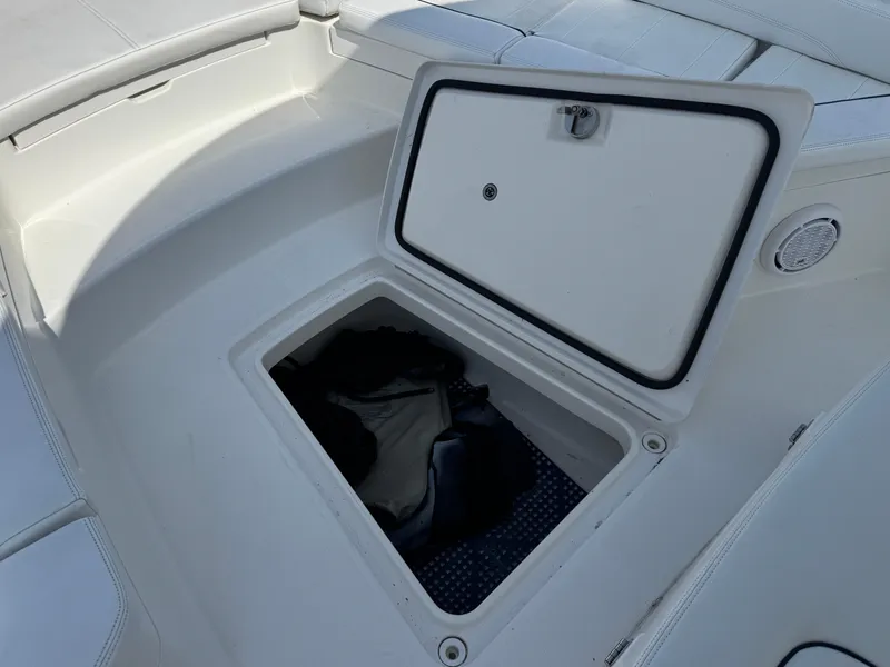 Slide: The Image of 2020 Regulator 26XO boat storage compartment with open hatch. - 32