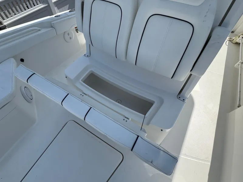 Slide: The Image of 2020 Regulator 26XO boat interior with white seating and storage compartment. - 34