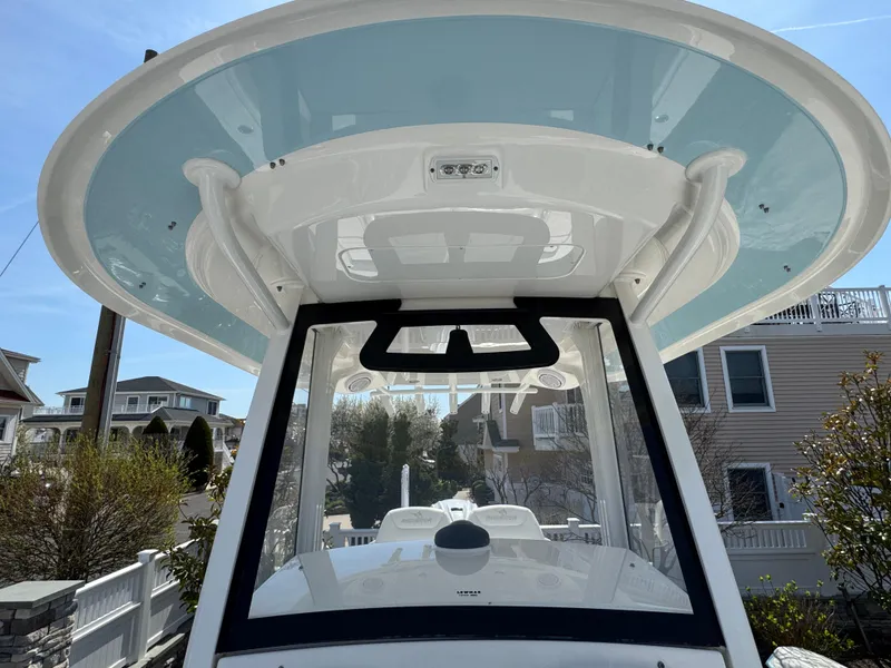 Slide: The Image of 2020 Regulator 26XO boat with T-top, docked in a residential area. - 35