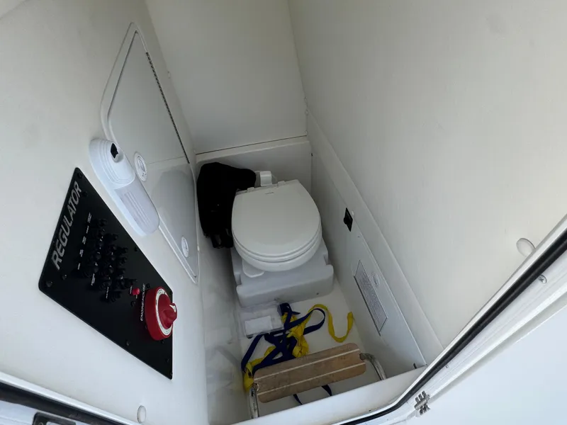 Slide: The Image of 2020 Regulator 26XO boat interior with toilet and control panel. - 38
