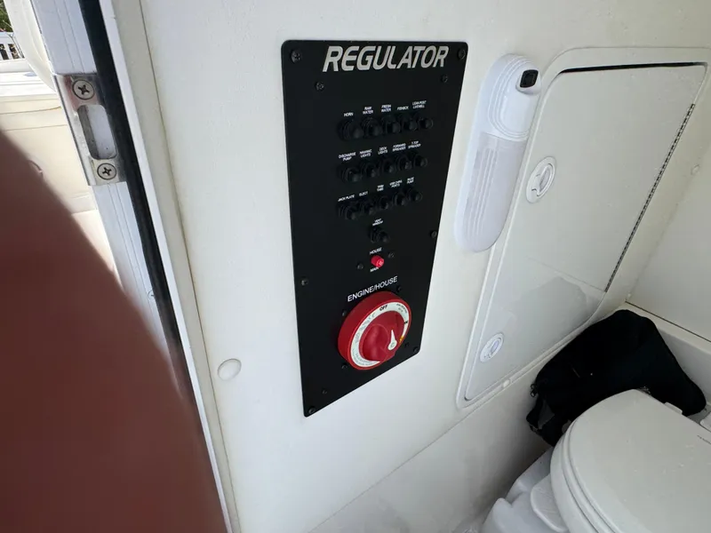 Slide: The Image of Control panel of a 2020 Regulator 26XO boat, featuring switches and an engine start button. - 39