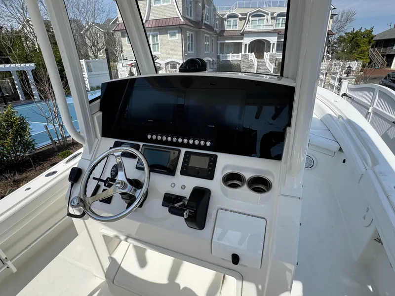 Slide: The Image of 2020 Regulator 26XO boat console with steering wheel and navigation controls. - 42