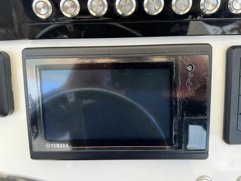 Slide: The Image of Yamaha display on 2020 Regulator 26XO boat dashboard with control buttons. - 44