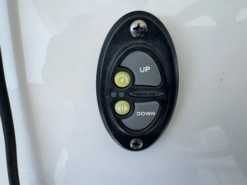 Slide: The Image of Power-Pole control panel on 2020 Regulator 26XO boat, featuring up and down buttons. - 47
