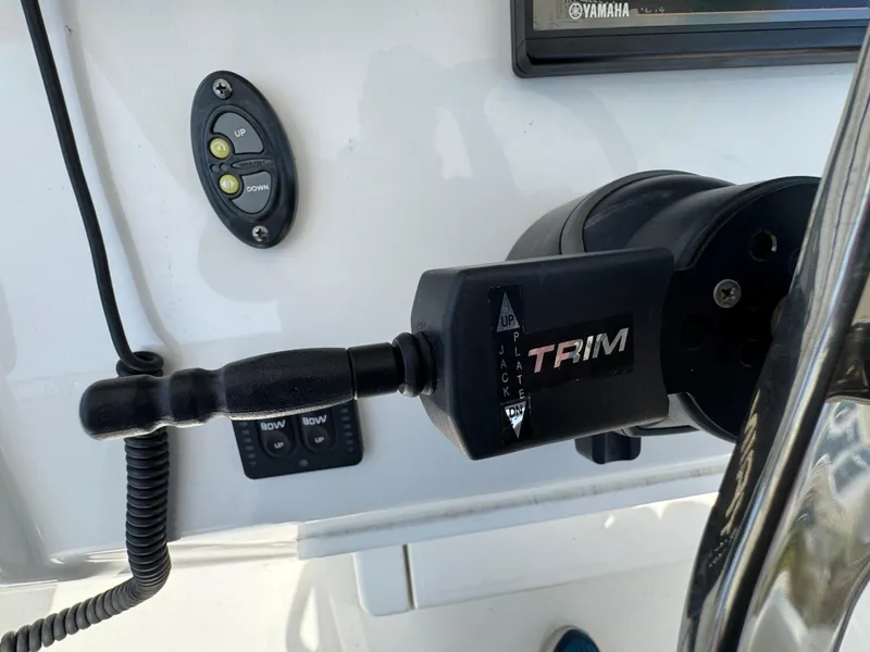 Slide: The Image of Control panel of a 2020 Regulator 26XO boat with trim and navigation buttons. - 48