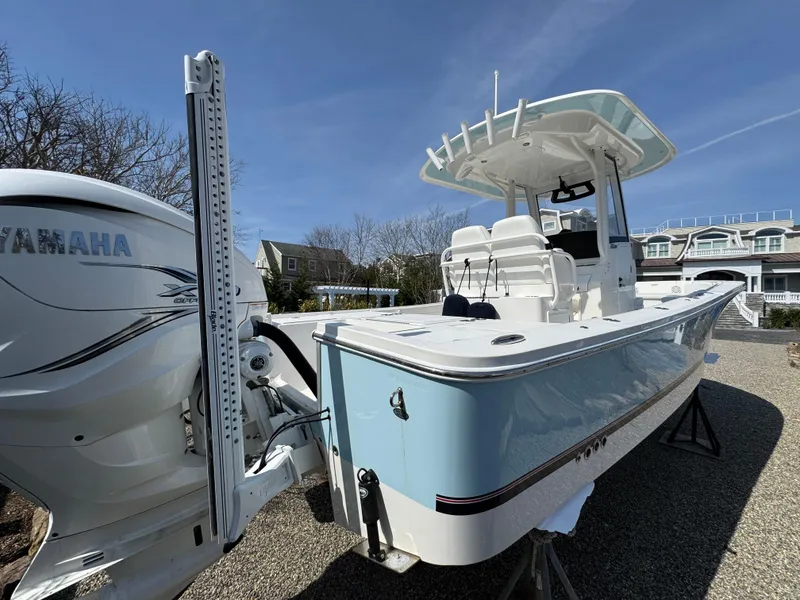 Slide: The Image of 2020 Regulator 26XO boat with Yamaha engine, docked outdoors under clear blue sky. - 5