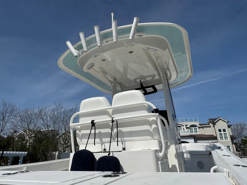 Slide: The Image of 2020 Regulator 26XO boat with T-top and seating, under clear blue sky. - 6
