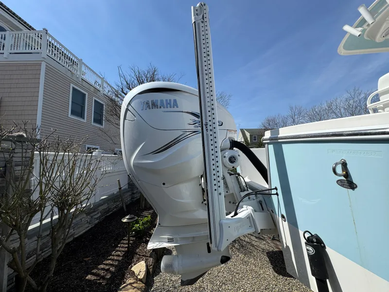 Slide: The Image of 2020 Regulator 26XO boat with Yamaha outboard motor, parked outdoors. - 7