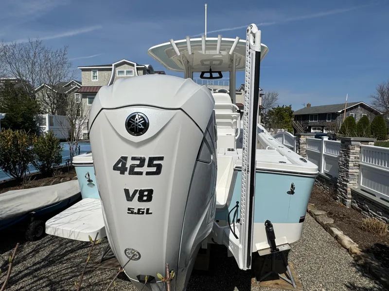 Slide: The Image of 2020 Regulator 26XO boat with Yamaha 425 V8 engine, parked outdoors. - 8