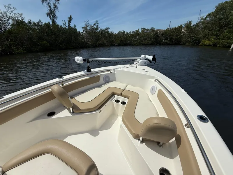 Slide: The Image of 2020 Key West 203 FS boat with tan seating on a calm river. - 11