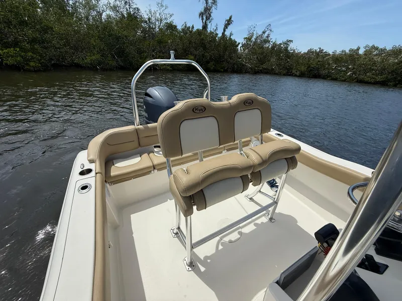 Slide: The Image of 2020 Key West 203 FS boat interior with tan seating on a calm river. - 6