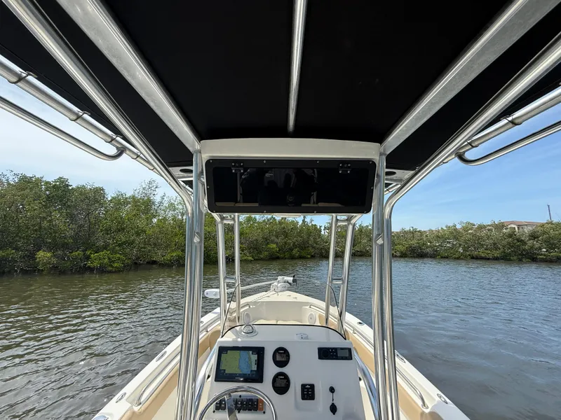 Slide: The Image of 2020 Key West 203 FS boat interior with console, navigating through calm waters. - 8