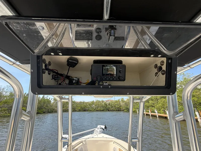 Slide: The Image of 2020 Key West 203 FS boat console with electronics, cruising on a scenic waterway. - 9