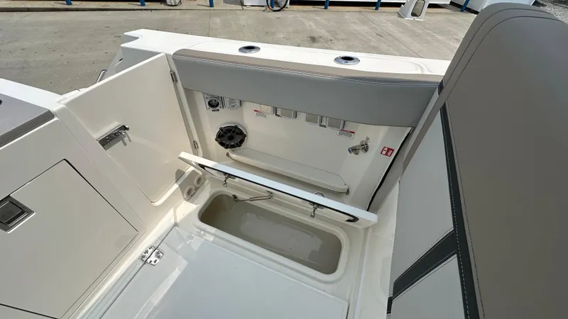 Slide: The Image of 2025 Boston Whaler 330 Vantage boat interior, featuring storage compartments and seating area. - 10
