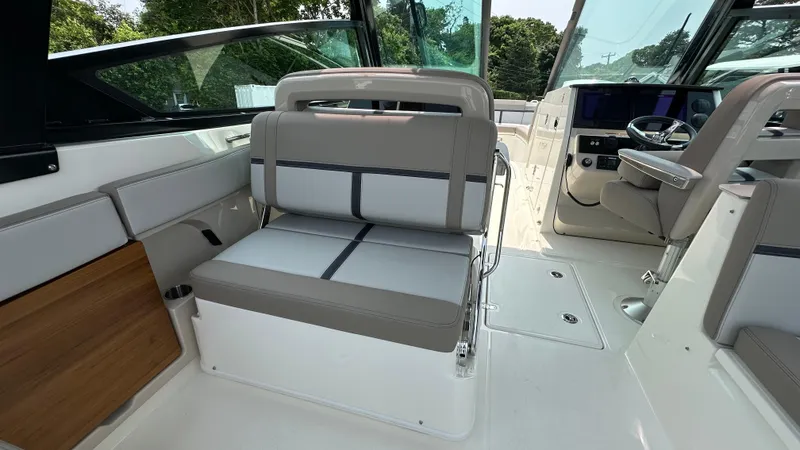 Slide: The Image of 2025 Boston Whaler 330 Vantage interior with seating and helm, showcasing modern design. - 12