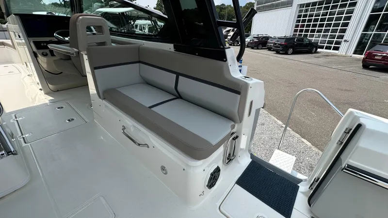Slide: The Image of 2025 Boston Whaler 330 Vantage boat interior with gray seating and modern design. - 14