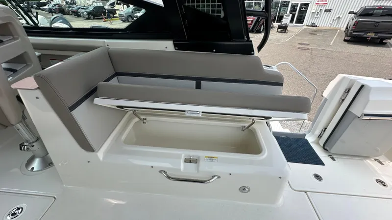 Slide: The Image of 2025 Boston Whaler 330 Vantage boat seat with storage compartment open. - 15