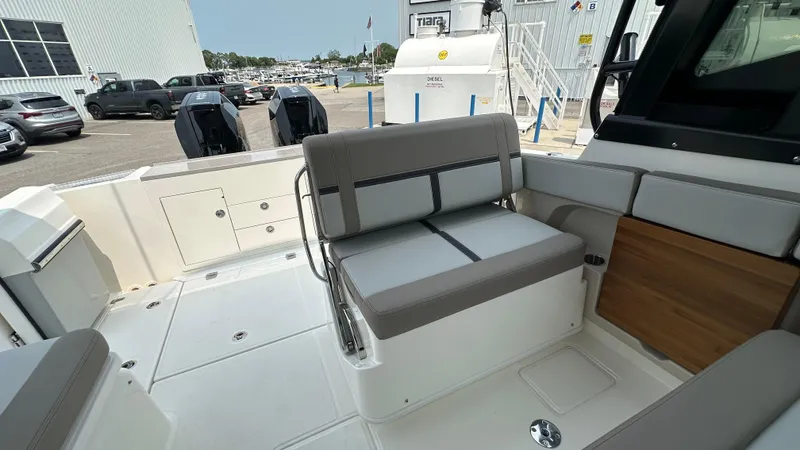 Slide: The Image of 2025 Boston Whaler 330 Vantage boat interior with seating and deck view. - 16