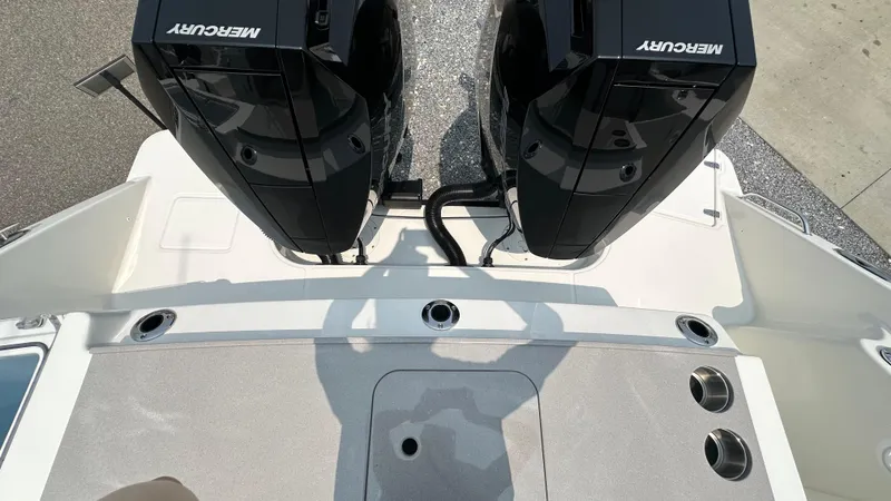 Slide: The Image of 2025 Boston Whaler 330 Vantage boat with dual Mercury engines, viewed from above. - 2