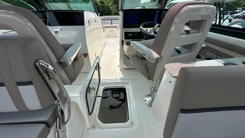 Slide: The Image of 2025 Boston Whaler 330 Vantage interior with seating and storage compartments. - 25