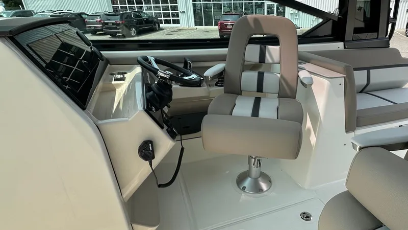 Slide: The Image of 2025 Boston Whaler 330 Vantage helm with modern controls and comfortable seating. - 26