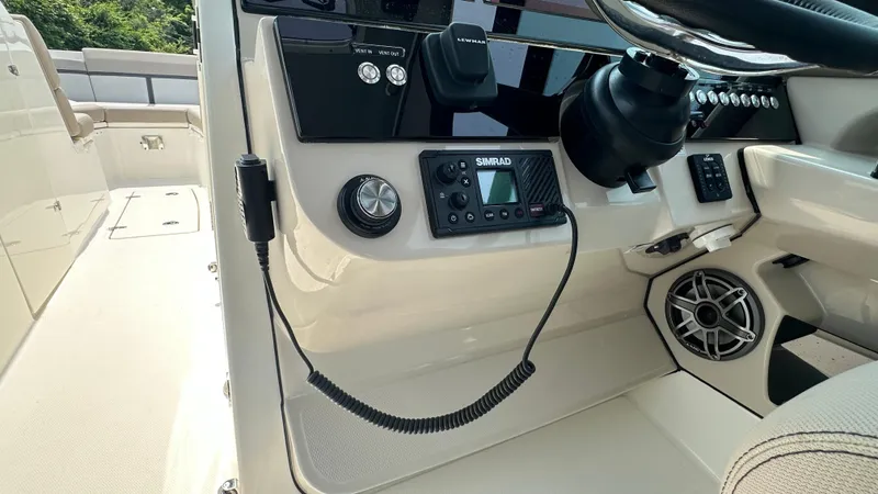 Slide: The Image of 2025 Boston Whaler 330 Vantage dashboard with Simrad electronics and speaker system. - 29