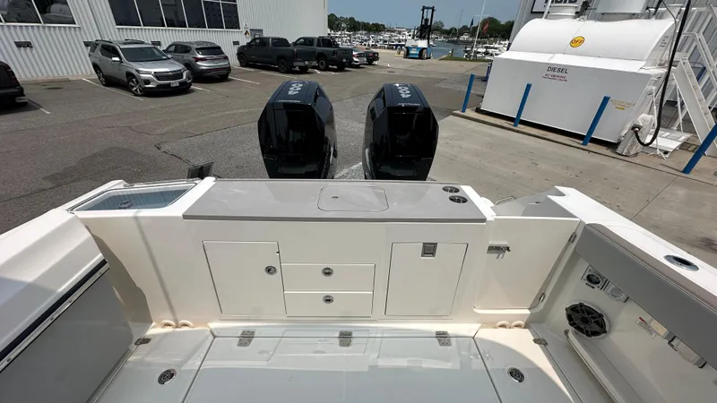 Slide: The Image of 2025 Boston Whaler 330 Vantage boat with dual engines, docked at a marina. - 3