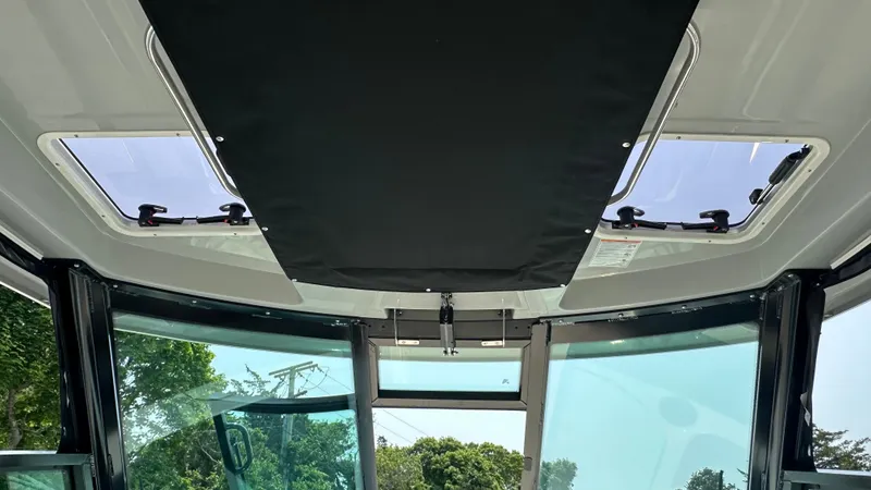 Slide: The Image of Interior view of 2025 Boston Whaler 330 Vantage boat with sunroof and windows. - 30