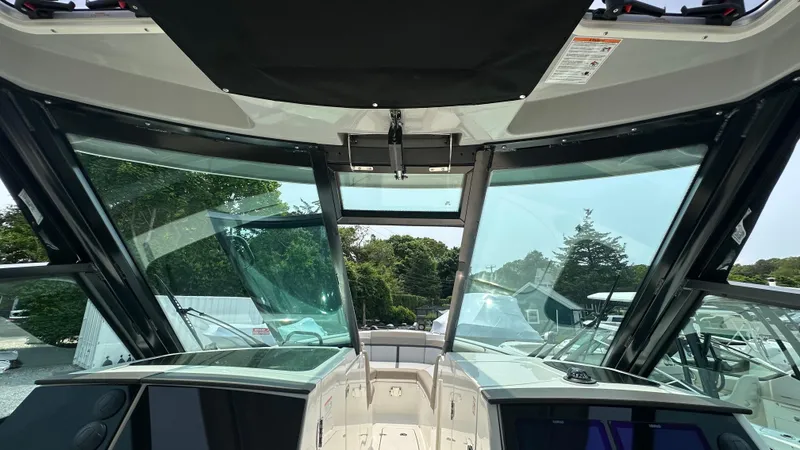 Slide: The Image of 2025 Boston Whaler 330 Vantage boat interior with panoramic windshield view. - 31