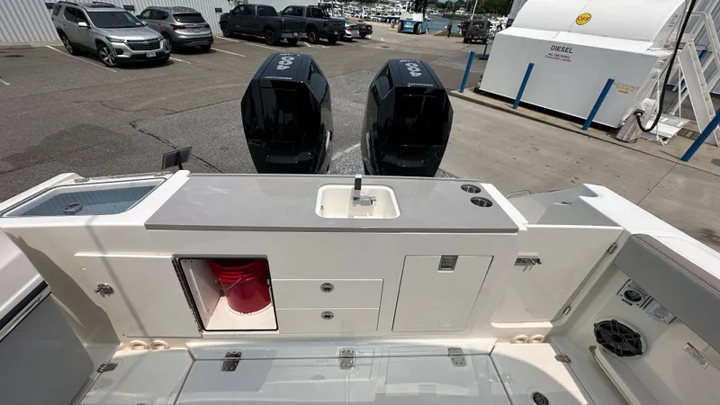 Slide: The Image of 2025 Boston Whaler 330 Vantage boat with dual engines and onboard sink, docked at marina. - 4