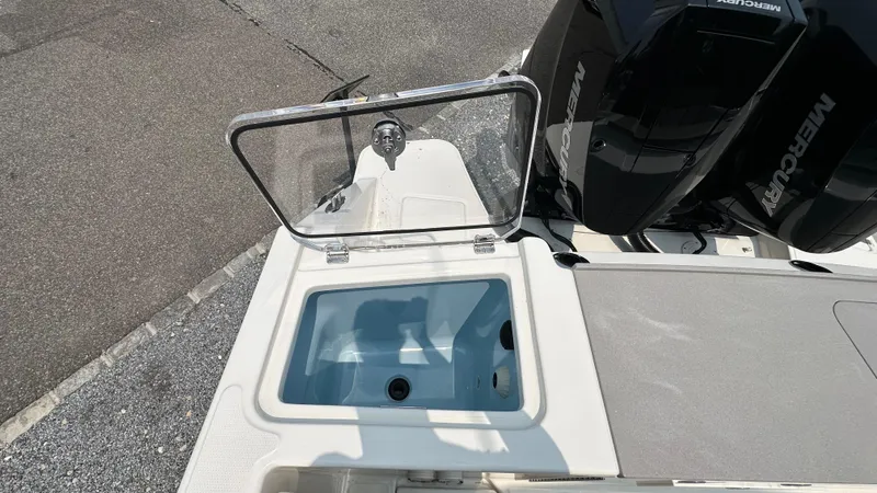 Slide: The Image of 2025 Boston Whaler 330 Vantage boat with open storage compartment and Mercury engines. - 5