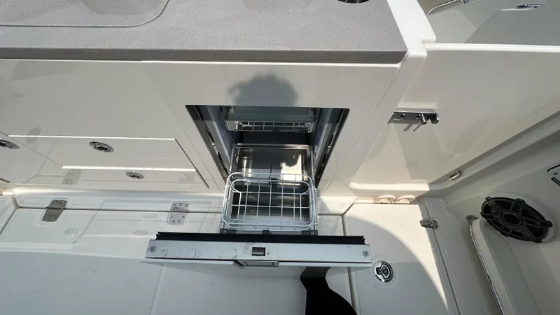 Slide: The Image of 2025 Boston Whaler 330 Vantage boat interior with open drawer and storage space. - 6
