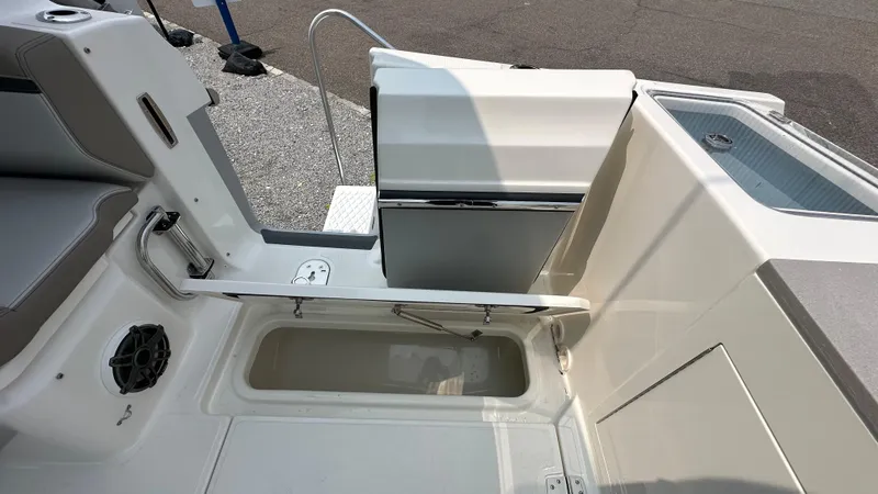 Slide: The Image of 2025 Boston Whaler 330 Vantage boat interior, featuring storage compartment and seating area. - 9